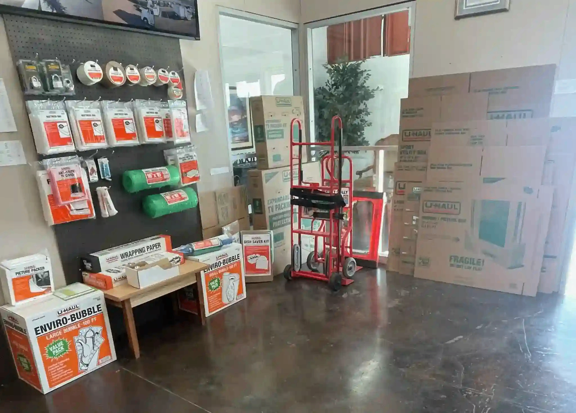 Moving supplies wall with U-Haul boxes and packing materials at Sunbrook Secure Storage