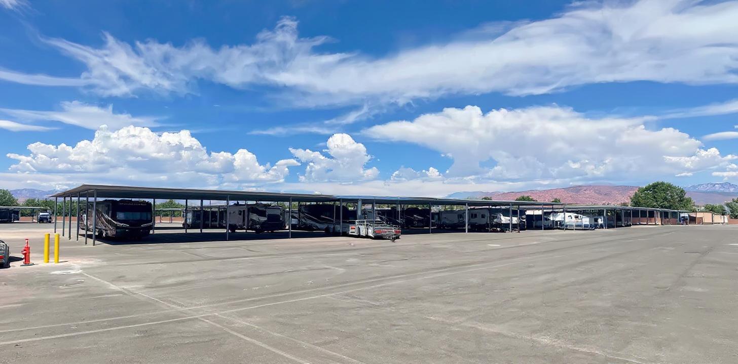 Panoramic view of covered RV and boat storage areas with beautiful mountain backdrop